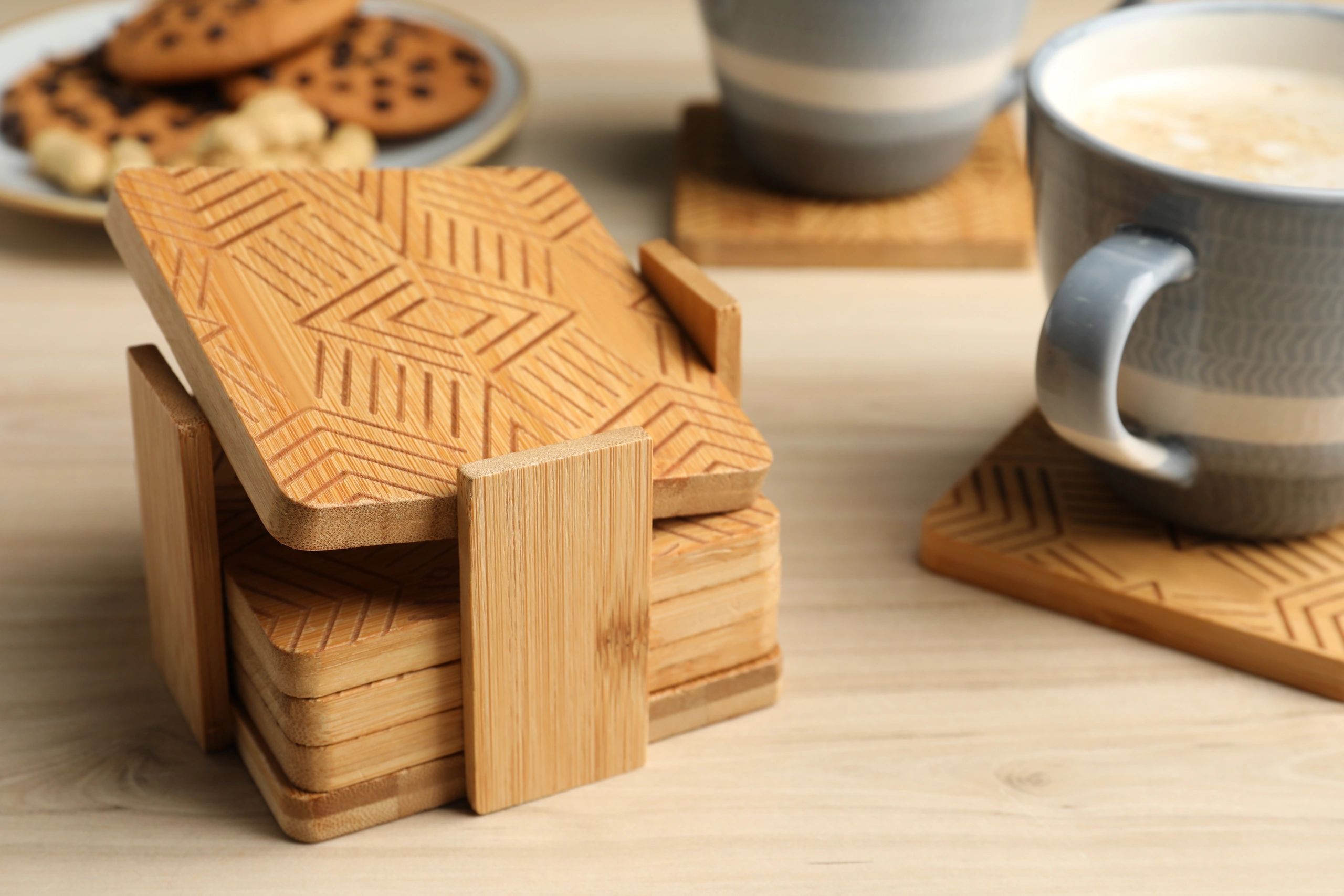 Wooden coasters and mugs on a table