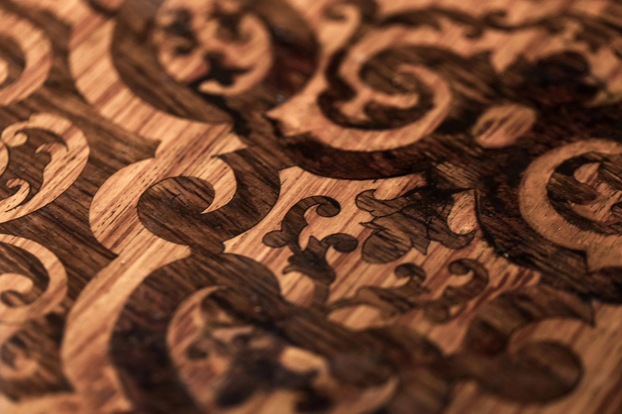 Macro of engraved ornamental design on wood surface
